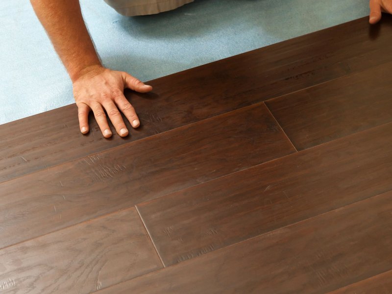 person installing flooring from Solutions in West Fargo