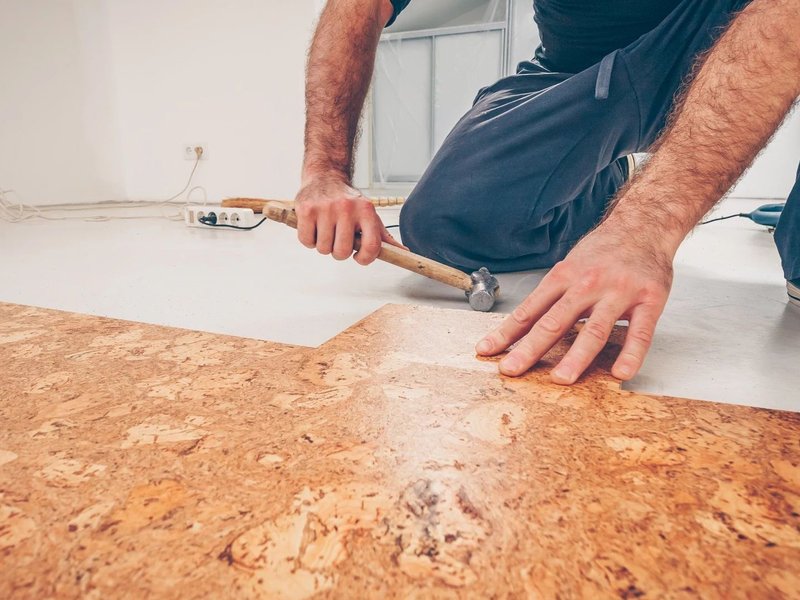 man installing cork floors from Solutions in West Fargo