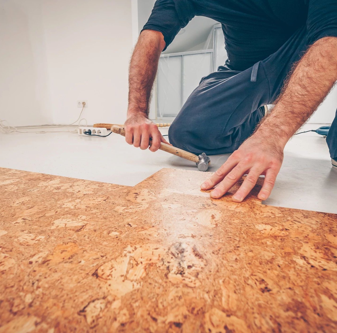 man installing cork floors from Solutions in West Fargo