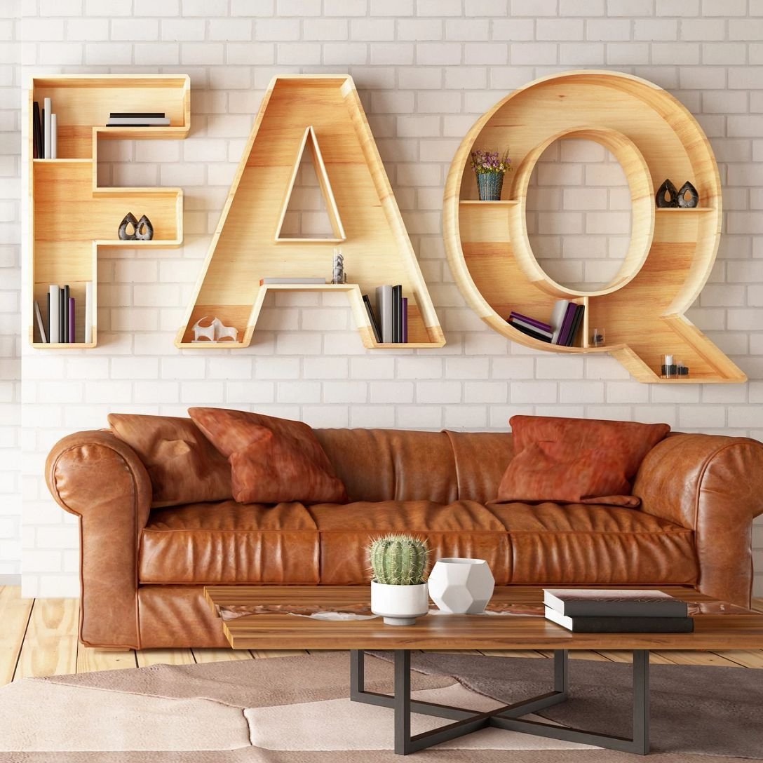 couch and coffee table with FAQ on the wall behind from Solutions in West Fargo