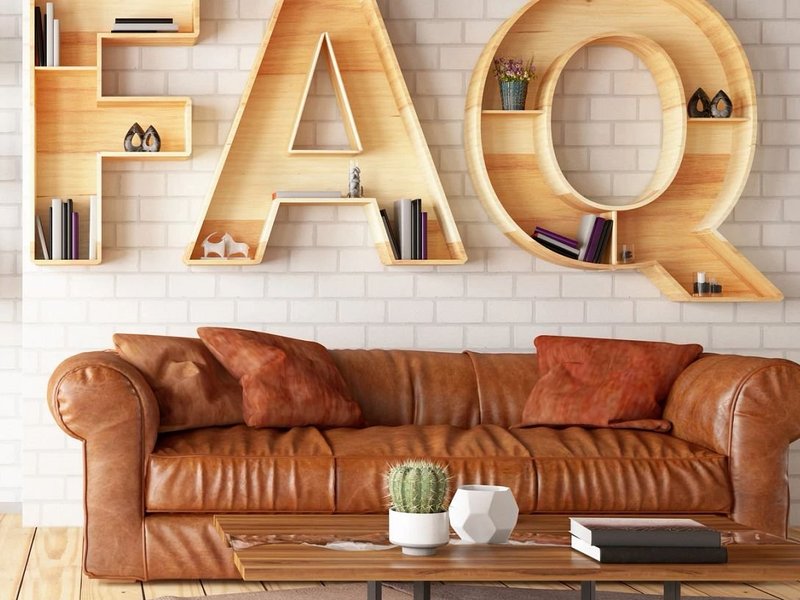 couch and coffee table with FAQ on the wall behind from Solutions in West Fargo