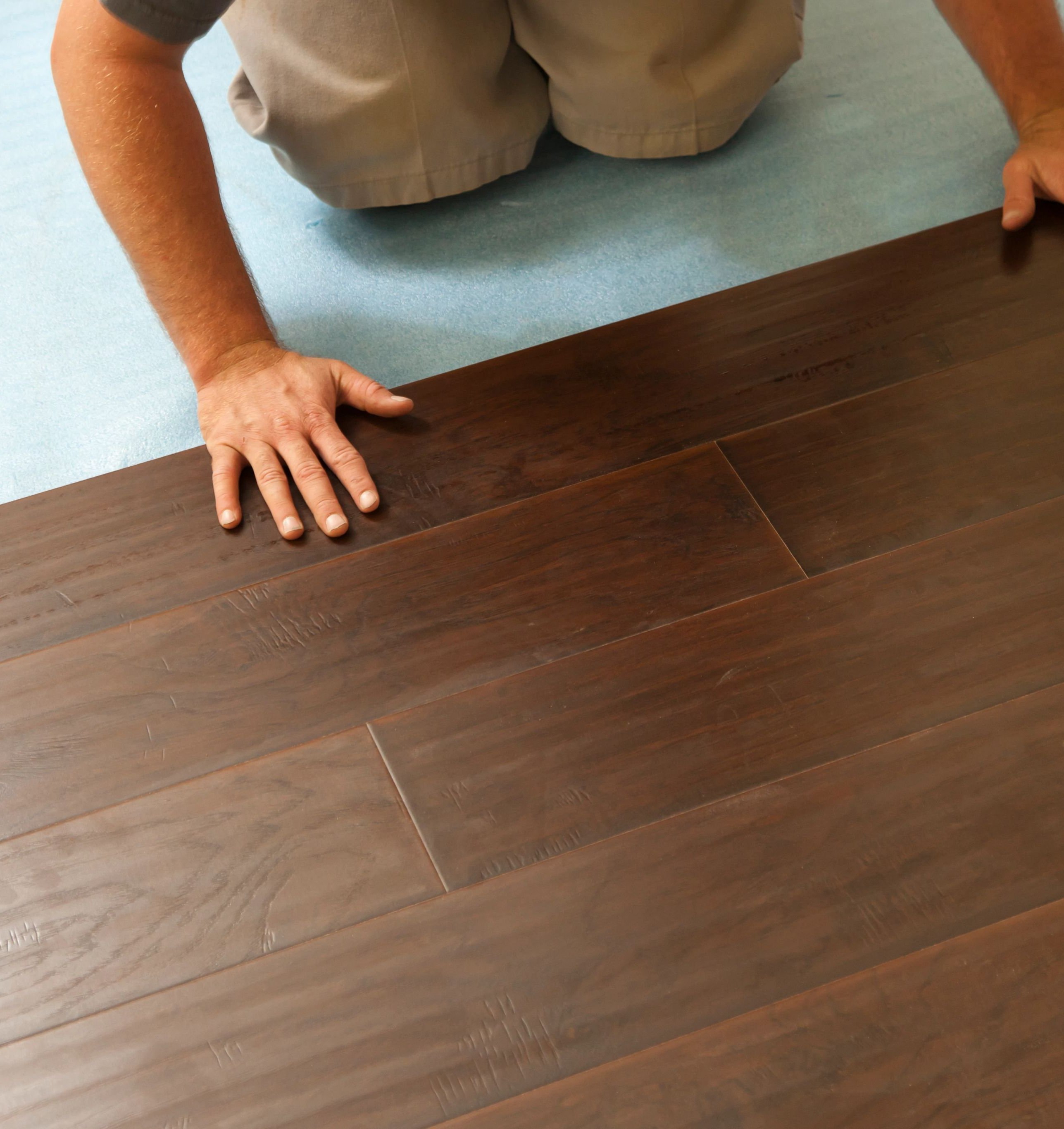 person installing flooring from Solutions in West Fargo
